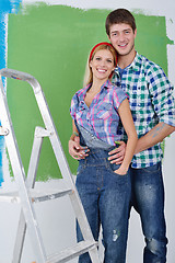 Image showing happy couple paint wall at new home