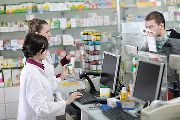 Image showing pharmacist suggesting medical drug to buyer in pharmacy drugstor