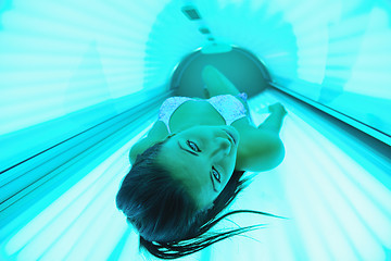 Image showing Beautiful young woman tanning in solarium