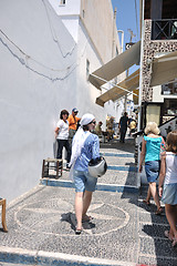 Image showing Greek woman on the streets of Oia, Santorini, Greece