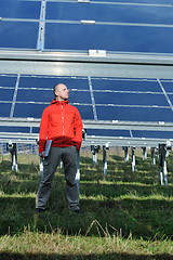 Image showing engineer using laptop at solar panels plant field