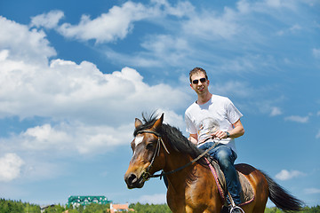 Image showing man ride horse