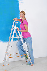 Image showing happy couple paint wall at new home