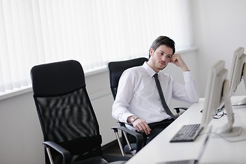 Image showing tired and depresed young business man at office