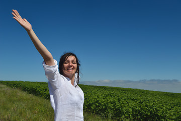 Image showing Young happy woman in green field