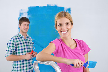 Image showing happy couple paint wall at new home