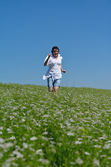 Image showing Young happy woman in green field