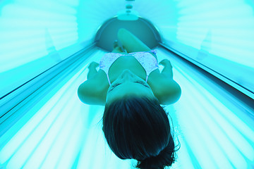 Image showing Beautiful young woman tanning in solarium