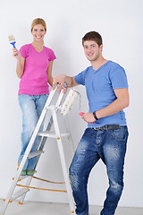 Image showing happy couple paint wall at new home