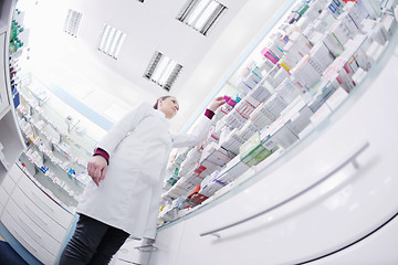 Image showing pharmacist chemist woman standing in pharmacy drugstore