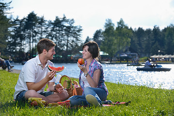 Image showing happy young couple having a picnic outdoor