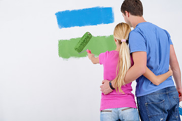 Image showing happy couple paint wall at new home