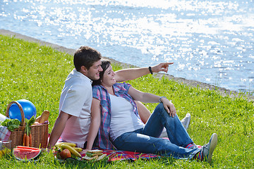 Image showing happy young couple having a picnic outdoor