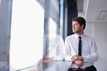 Image showing business man  on a meeting in offce with colleagues in backgroun