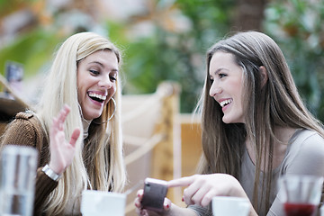 Image showing cute smiling women drinking a coffee