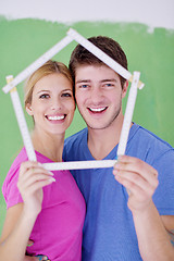 Image showing happy couple paint wall at new home