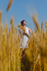 Image showing young woman in wheat field at summer