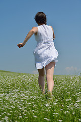 Image showing Young happy woman in green field