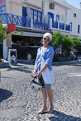 Image showing Greek woman on the streets of Oia, Santorini, Greece