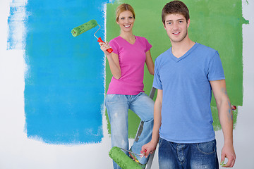 Image showing happy couple paint wall at new home