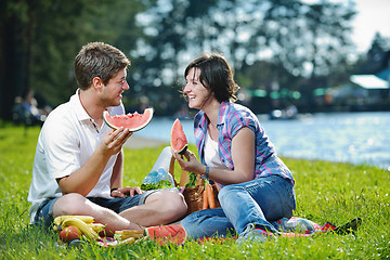 Image showing happy young couple having a picnic outdoor