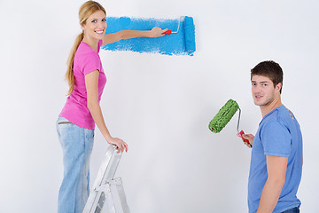 Image showing happy couple paint wall at new home