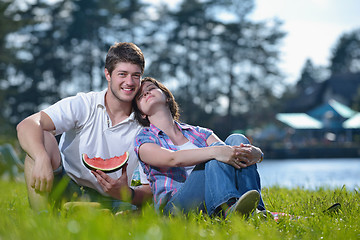 Image showing happy young couple having a picnic outdoor