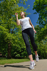 Image showing Young beautiful  woman jogging at morning in park