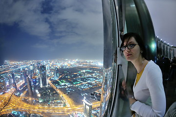 Image showing beautiful woman portrait with big city at night in background