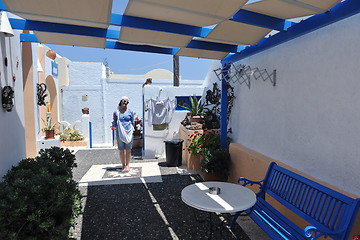 Image showing Greek woman on the streets of Oia, Santorini, Greece