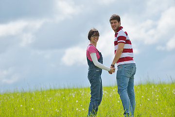 Image showing Portrait of romantic young couple smiling together outdoor