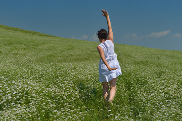 Image showing Young happy woman in green field