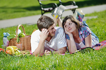 Image showing happy young couple having a picnic outdoor