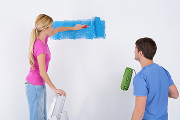 Image showing happy couple paint wall at new home