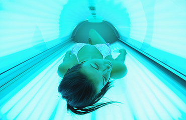 Image showing Beautiful young woman tanning in solarium