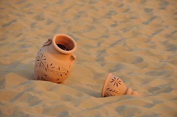 Image showing arabic pot in sand