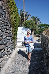 Image showing Greek woman on the streets of Oia, Santorini, Greece