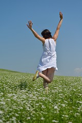 Image showing Young happy woman in green field