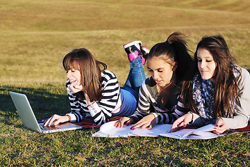 Image showing group of teens working on laptop outdoor