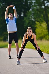 Image showing Couple doing stretching exercise  after jogging