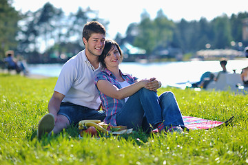 Image showing happy young couple having a picnic outdoor