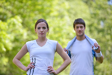 Image showing Couple doing stretching exercise  after jogging