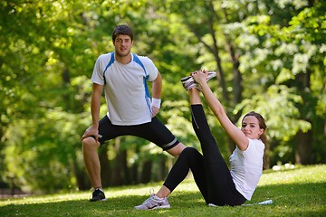 Image showing Couple doing stretching exercise  after jogging