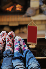 Image showing Young romantic couple sitting and relaxing in front of fireplace