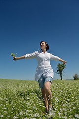 Image showing Young happy woman in green field