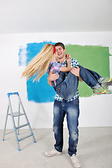 Image showing happy couple paint wall at new home