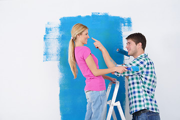 Image showing happy couple paint wall at new home