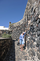 Image showing Greek woman on the streets of Oia, Santorini, Greece