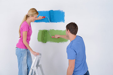 Image showing happy couple paint wall at new home