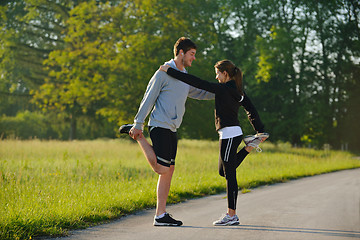 Image showing Couple doing stretching exercise  after jogging